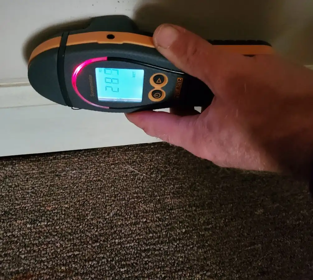 Moisture detection at baseboard during Storm Damage Restoration in Morrisville